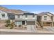 Charming two-story home featuring solar panels and a meticulously landscaped front yard against a mountain backdrop at 21186 W Hillcrest Blvd, Buckeye, AZ 85396