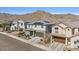 Charming two-story home featuring solar panels and a meticulously landscaped front yard against a mountain backdrop at 21186 W Hillcrest Blvd, Buckeye, AZ 85396