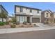 Attractive two-story home featuring a landscaped front yard and a two-car garage at 21186 W Hillcrest Blvd, Buckeye, AZ 85396