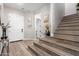Welcoming foyer with hardwood floors, an open staircase, and stylish decor creating an inviting entrance at 21186 W Hillcrest Blvd, Buckeye, AZ 85396