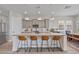 Modern kitchen featuring an island with seating, stainless steel appliances, and pendant lighting at 21186 W Hillcrest Blvd, Buckeye, AZ 85396