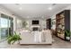 Inviting living room featuring stylish decor, a cozy fireplace, and backyard access through glass doors at 21186 W Hillcrest Blvd, Buckeye, AZ 85396