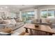 Bright living room with stylish furniture, a sliding glass door to the backyard, and views of the mountains at 21186 W Hillcrest Blvd, Buckeye, AZ 85396
