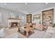 Bright living room showcasing a fireplace, built-in shelving, and comfortable seating at 21186 W Hillcrest Blvd, Buckeye, AZ 85396