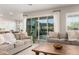 Bright living room with sliding glass door and comfortable furniture and large windows at 21186 W Hillcrest Blvd, Buckeye, AZ 85396