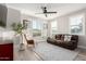 Cozy living room with hardwood floors, plush sofa, and bright windows at 21186 W Hillcrest Blvd, Buckeye, AZ 85396