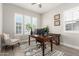 Bright office featuring a neutral color palette, plantation shutters, and a modern desk setup at 21186 W Hillcrest Blvd, Buckeye, AZ 85396