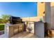 Outdoor kitchen featuring stone countertops, a built-in grill, and a mini-refrigerator at 21186 W Hillcrest Blvd, Buckeye, AZ 85396
