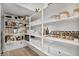 Well-organized walk-in pantry features white shelving and ample storage space for food and kitchen essentials at 21186 W Hillcrest Blvd, Buckeye, AZ 85396