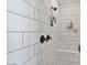 Modern shower with sleek white subway tile, brushed-nickel fixtures, and a built-in bench at 21186 W Hillcrest Blvd, Buckeye, AZ 85396