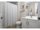 Cozy bathroom with a modern vanity, striped shower curtain, and tasteful decor at 22858 E Marsh Rd, Queen Creek, AZ 85142