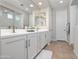 Bright bathroom featuring double vanity sinks, white cabinetry, and modern fixtures at 22858 E Marsh Rd, Queen Creek, AZ 85142