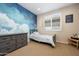 Comfortable bedroom showcasing a cloud mural, neutral carpet, and a well-lit window at 22858 E Marsh Rd, Queen Creek, AZ 85142