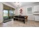 Bright dining room with a farmhouse table and sliding doors to the outdoor living area at 22858 E Marsh Rd, Queen Creek, AZ 85142