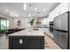 Modern kitchen with stainless steel appliances, a large island, and a dining area with contemporary lighting at 22858 E Marsh Rd, Queen Creek, AZ 85142