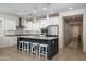 Modern kitchen with stainless steel appliances, a large island with seating, and white cabinetry at 22858 E Marsh Rd, Queen Creek, AZ 85142