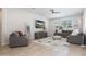 Bright and airy living room featuring comfortable seating, a stylish rug, and a ceiling fan at 22858 E Marsh Rd, Queen Creek, AZ 85142