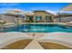 Relaxing pool area featuring chaise lounges, umbrellas, water feature, and a view of the house at 22858 E Marsh Rd, Queen Creek, AZ 85142