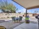 View of back patio with table, chairs, grill, and garden accents at 23882 W Yavapi St, Buckeye, AZ 85326