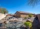 Expansive backyard features desert landscaping with gravel ground cover and outdoor seating areas at 23882 W Yavapi St, Buckeye, AZ 85326