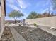 Backyard view features stone pathway, gravel, and brick perimeter at 23882 W Yavapi St, Buckeye, AZ 85326