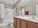 Bright bathroom featuring a vanity with wooden cabinets, sink, and tub with shower at 23882 W Yavapi St, Buckeye, AZ 85326