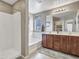 Bright bathroom with double sink vanity, tub, and walk-in shower at 23882 W Yavapi St, Buckeye, AZ 85326