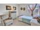 Cozy bedroom with a twin bed, dresser, accent chair and natural light at 23882 W Yavapi St, Buckeye, AZ 85326