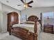 Bedroom features decorative wood bed frame, ceiling fan and carpeted floors at 23882 W Yavapi St, Buckeye, AZ 85326