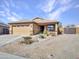 Charming single-story home featuring a low-maintenance desert landscape and neutral color scheme at 23882 W Yavapi St, Buckeye, AZ 85326