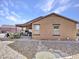 Back of house featuring a covered patio and rock landscaping at 23882 W Yavapi St, Buckeye, AZ 85326