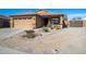 Inviting single-story home with desert landscaping, a two-car garage, and a cozy front porch at 23882 W Yavapi St, Buckeye, AZ 85326