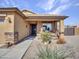 Inviting covered front porch with decorative plants, adding charm to the home's entrance at 23882 W Yavapi St, Buckeye, AZ 85326