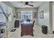 Well-lit home office featuring a ceiling fan and large desk at 23882 W Yavapi St, Buckeye, AZ 85326