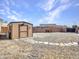 Backyard view with shed along with rock groundcover at 23882 W Yavapi St, Buckeye, AZ 85326