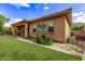 Exterior shot of backyard featuring artificial grass, gravel, and desert landscaping at 2436 W Kachina Trl, Phoenix, AZ 85041