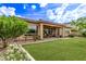 Lush backyard with a covered patio area perfect for outdoor entertaining and relaxation at 2436 W Kachina Trl, Phoenix, AZ 85041