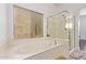 Bathroom with a soaking tub and separate glass-enclosed shower under a window at 2436 W Kachina Trl, Phoenix, AZ 85041