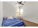 Bedroom features a blue patterned comforter and a window with table and chairs at 2436 W Kachina Trl, Phoenix, AZ 85041