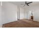 Empty bedroom boasts neutral walls, carpet, and entrances to an ensuite bathroom at 2436 W Kachina Trl, Phoenix, AZ 85041