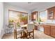 Bright breakfast nook features a table, chairs, built-in desk, and a large window with views at 2436 W Kachina Trl, Phoenix, AZ 85041