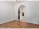 Hallway features wood-look tile flooring and an arched doorway to the kitchen at 2436 W Kachina Trl, Phoenix, AZ 85041