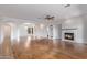 Spacious living room featuring wood floors, fireplace, and archways leading to other rooms at 2436 W Kachina Trl, Phoenix, AZ 85041