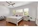 Bright main bedroom featuring wood floors, a ceiling fan, and large windows at 2436 W Kachina Trl, Phoenix, AZ 85041