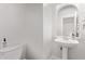 Clean powder room with pedestal sink, toilet, and mirror at 2436 W Kachina Trl, Phoenix, AZ 85041