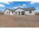 Wide view of the house's backyard with a large dirt area and a covered patio at 2438 N 113Th St, Mesa, AZ 85207