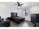 Well-lit bedroom with ceiling fan and dark furniture at 2438 N 113Th St, Mesa, AZ 85207