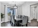 Formal dining room with six upholstered chairs, a modern chandelier, and a window with desert views at 2438 N 113Th St, Mesa, AZ 85207