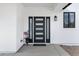 Modern front door with sidelights, black hardware, and American flags decoration at 2438 N 113Th St, Mesa, AZ 85207