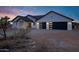 Stunning single-story home with modern garage doors and desert landscaping at 2438 N 113Th St, Mesa, AZ 85207